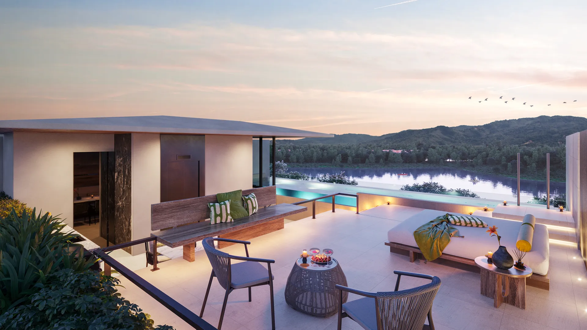 บันยันทรี บีช เรสซิเดนซ์ นัมมู- A luxurious outdoor terrace features plush seating, infinity pool, and lush greenery, overlooking a tranquil ocean under a clear blue sky.