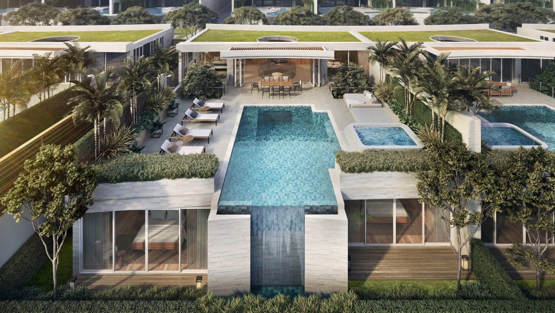 บันยันทรี บีช เรสซิเดนซ์ เอเกอร์ - A luxurious resort with rectangular pools, surrounded by palm trees, loungers, and modern structures, bathed in warm sunlight.