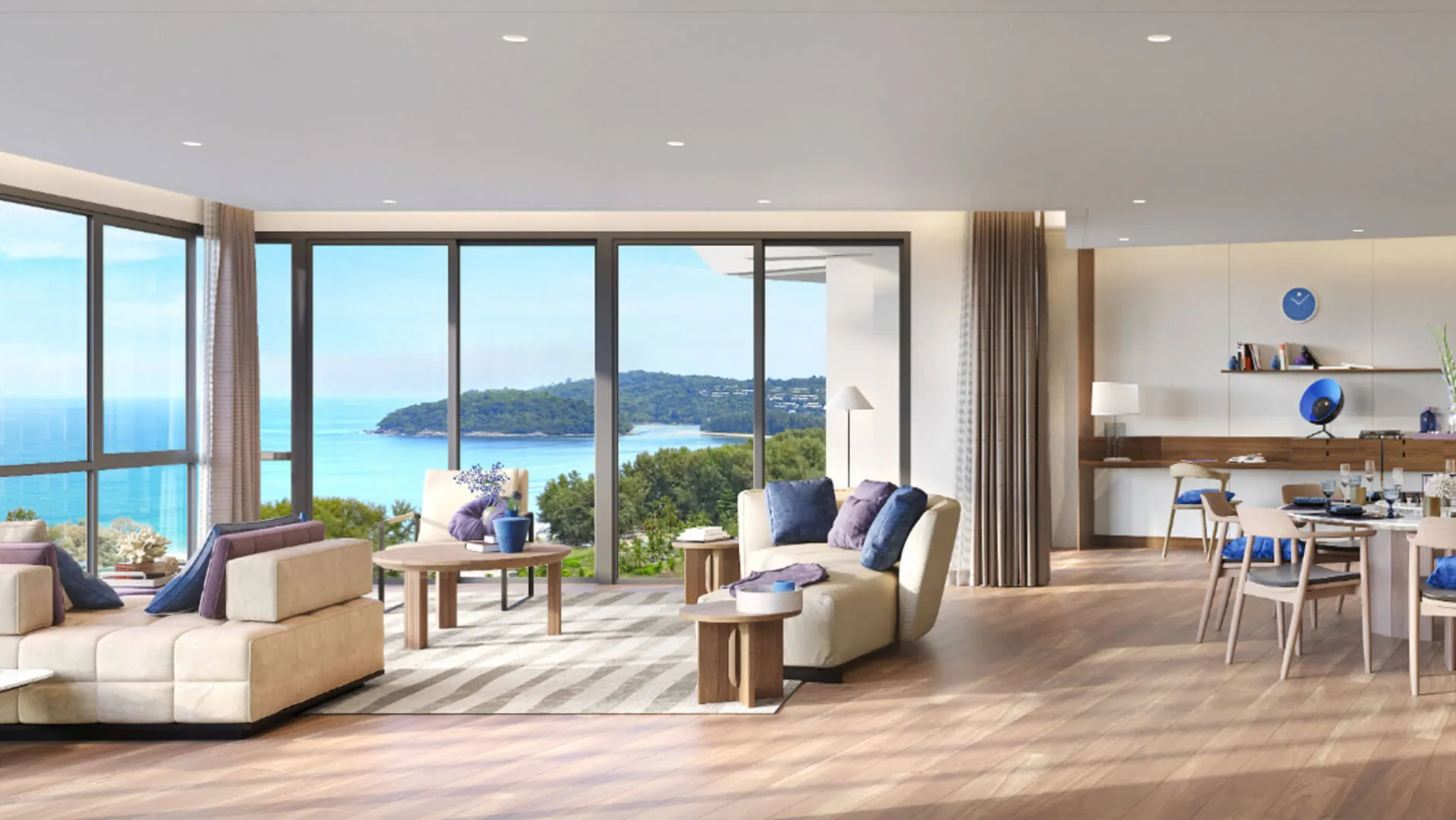 Banyan Tree Beach Residences Sirena - A modern living room with large windows showcasing a sea view, furnished with sofas, a dining table.