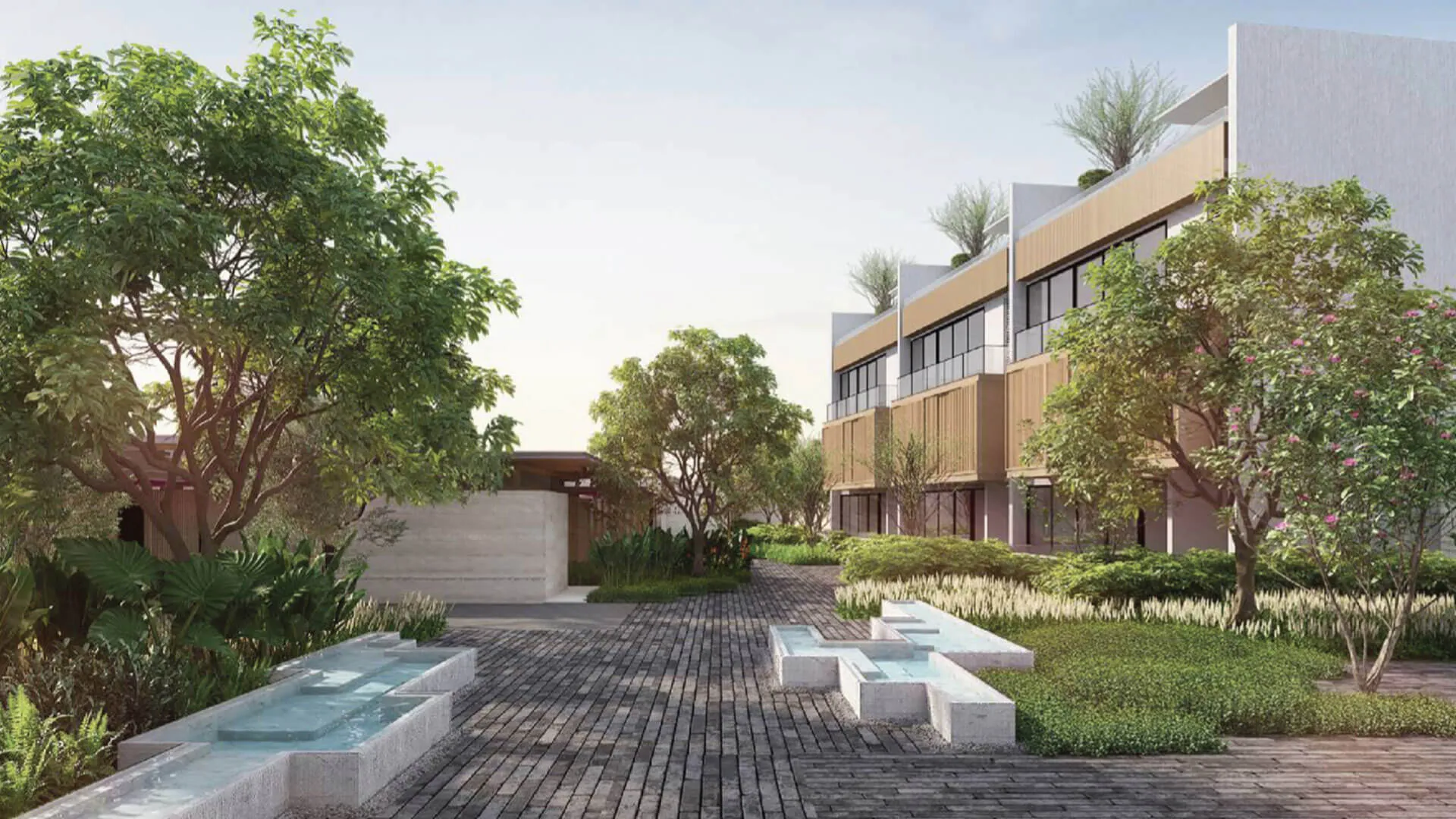 Banyan Tree Lake Residences Yara - Modern buildings with wooden features, surrounded by lush greenery and cobblestone paths. 